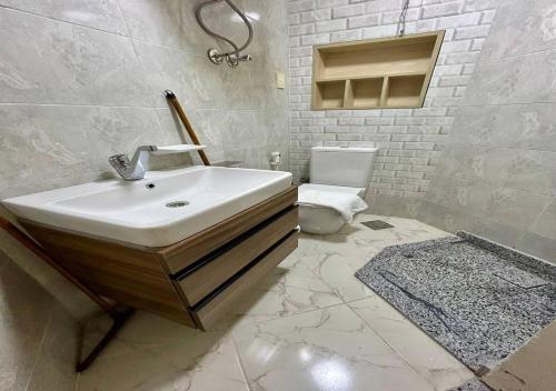 a white bathroom with a sink and a toilet at شاليهات بورتو مطروح فيو بحر Porto Matrouh Sea View Families Only in Marsa Matruh