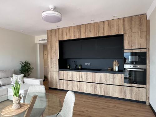 a living room with a large flat screen tv at Apartamento moderno centro Aguilas 150m playa in Águilas