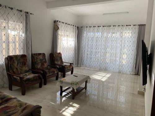 a living room with two chairs and a coffee table at Maison de Pagoda in Port Louis