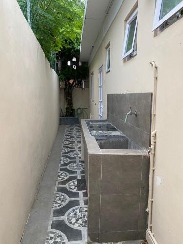 a bathroom with a sink on the side of a building at Maison de Pagoda in Port Louis