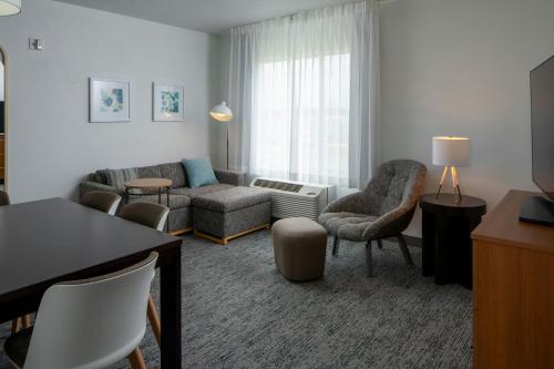 a living room with a couch and chairs at TownePlace Suites by Marriott Huntsville West/Redstone Gateway in Huntsville