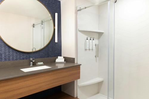 a bathroom with a sink and a mirror at Fairfield by Marriott Inn & Suites Spokane Airport in Spokane