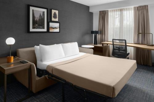 a hotel room with a bed and a desk at Residence Inn Salt Lake City Cottonwood in Cottonwood Heights