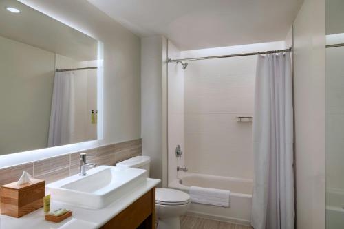 a white bathroom with a sink and a toilet at Element Albuquerque Uptown in Albuquerque