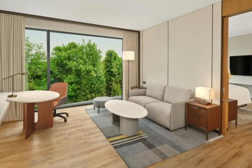 a living room with a couch and a table at Courtyard by Marriott Pyeongtaek in Pyeongtaek