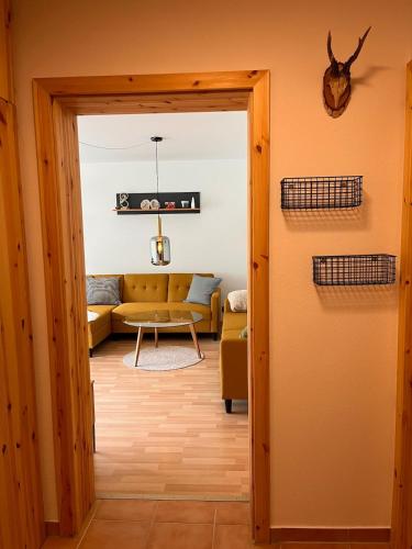 a view of a living room with a yellow couch at Die Ente an der Enz, mit Schwimmbad und Sauna in Bad Wildbad
