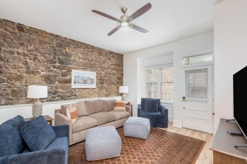 a living room with a couch and a brick wall at Stone Alley Condo condo in Telluride
