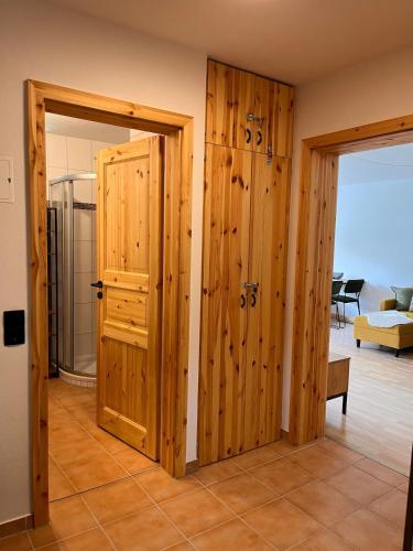 a room with wooden doors in a room with a living room at Die Ente an der Enz, mit Schwimmbad und Sauna in Bad Wildbad