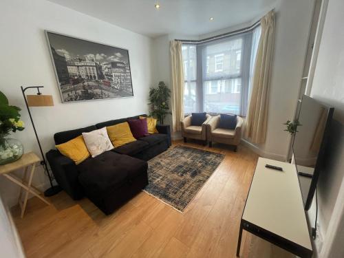 a living room with a couch and a table at beautifull house with 6 double bedrooms in London