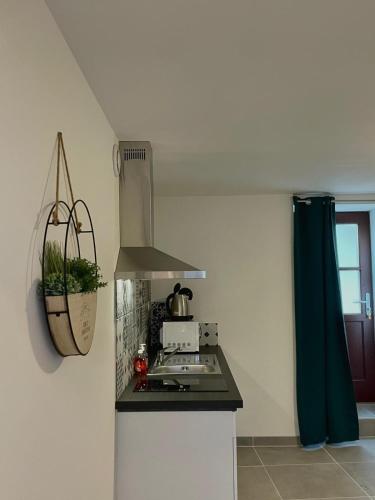 a kitchen with a stove top oven next to a window at Au cocon des promenades in Pesmes