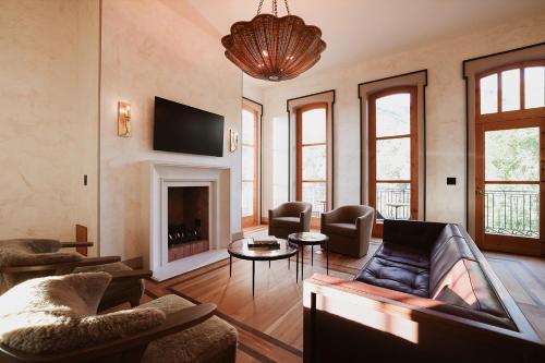 a living room with a couch and a fireplace at Surf Hotel & Chateau in Buena Vista