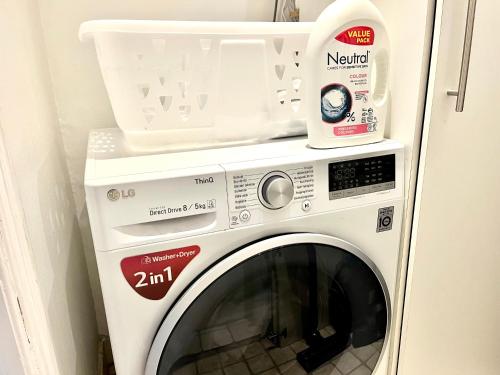 a washing machine with a container on top of it at Apartment Alma - Cosy Stay in Aalborg C in Aalborg