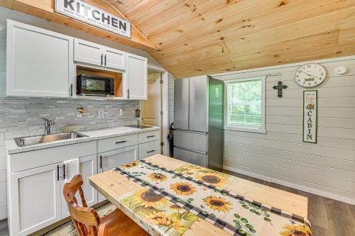 a kitchen with a table and a sink at 14 Mi to Kentucky Horse Park Creekside Cabin in Georgetown