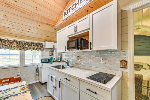 a kitchen with white cabinets and a sink at 14 Mi to Kentucky Horse Park Creekside Cabin in Georgetown
