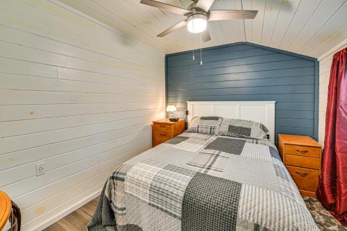 a bedroom with a bed and a blue wall at 14 Mi to Kentucky Horse Park Creekside Cabin in Georgetown