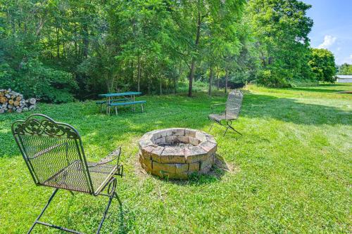 two chairs and a fire pit in a yard at 14 Mi to Kentucky Horse Park Creekside Cabin in Georgetown
