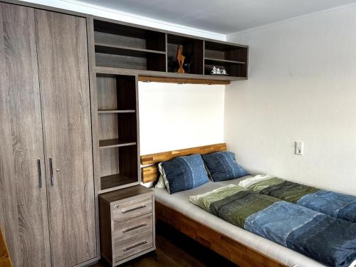 a bedroom with a bed and a wooden cabinet at Kitz-Studio in Größing