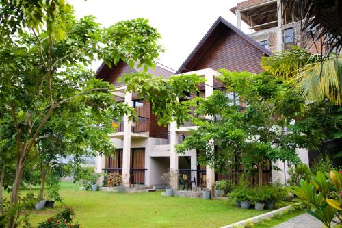 a building with trees in front of it at Woodgrove Cabanas in Negombo