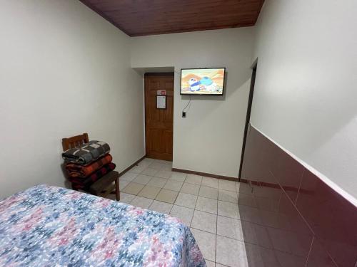a bedroom with a bed and a hallway with a door at Residencial Don Santiago in Talca