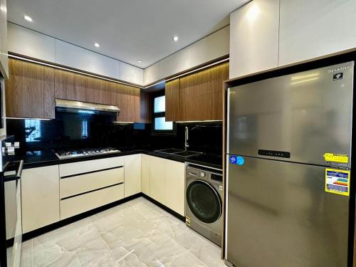 a kitchen with a washer and dryer in it at Urban Haven in Madinaty