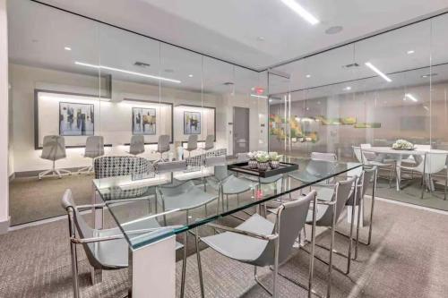 a dining room with a glass table and chairs at DOWNTOWN DORAL, FLORIDA. NEW CONDO STYLE RESORT. in Miami