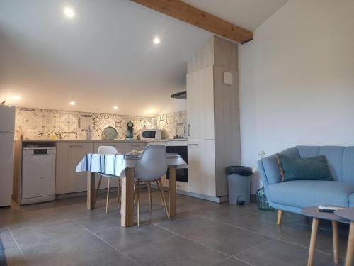 a kitchen and living room with a table and a couch at Selaurua in Sare