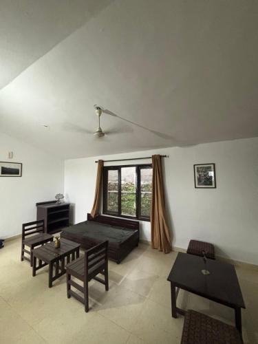 a living room with a couch and a table at Squirrel snuggle2 in Kota Bāgh