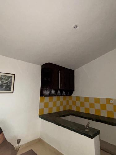 a kitchen with checkered counter top in a room at Squirrel snuggle2 in Kota Bāgh