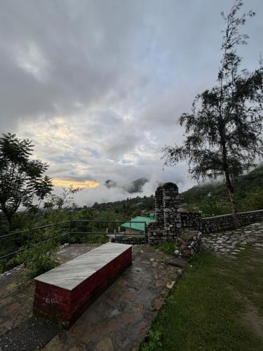 a bench sitting on the side of a hill with a pool at Squirrel snuggle2 in Kota Bāgh