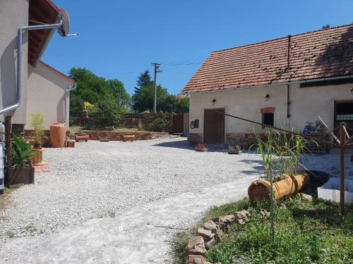 a house with a gravel driveway next to a building at Statek U Šimla in Lážovice