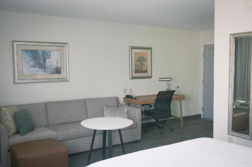 a living room with a couch and a table at Staybridge Suites Austin Airport by IHG in Austin