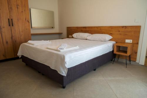 a bedroom with a large bed with two towels on it at Güneş Boutique Hotel - Oludeniz in Oludeniz