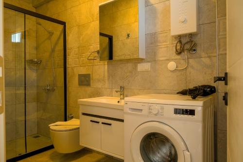 a bathroom with a washing machine and a sink at Güneş Boutique Hotel - Oludeniz in Oludeniz