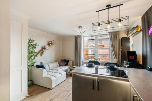 a kitchen and living room with a couch at Stylish Brayford Pool 2-Bed City Retreat in Lincoln