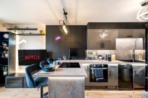 a kitchen with stainless steel appliances and a table at Stylish Brayford Pool 2-Bed City Retreat in Lincoln