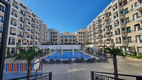 a large apartment building with a large swimming pool at Sunshine Rose - Sea view, Neubau, Luxus Apartment in Sveti Vlas
