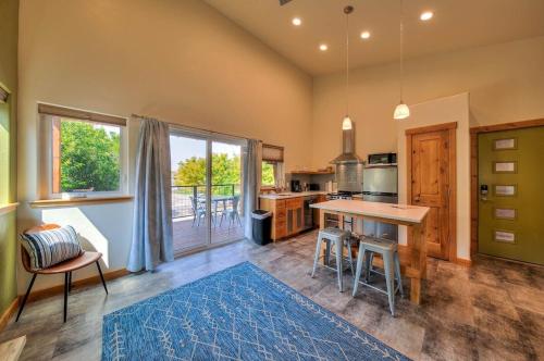 a kitchen with a table and a large window at Casa Moab 4 - In Town - Outdoor Sauna! in Moab