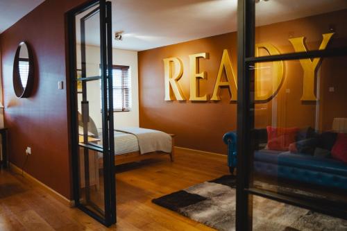 a room with a room with a bed and a mirror at No 1 - Bakewell in Bakewell