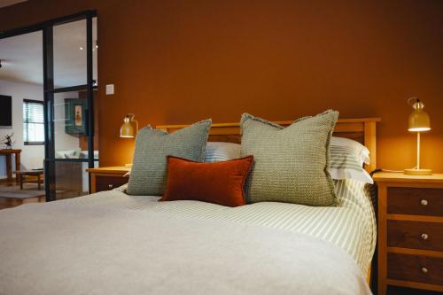 a bed with several pillows on top of it at No 1 - Bakewell in Bakewell