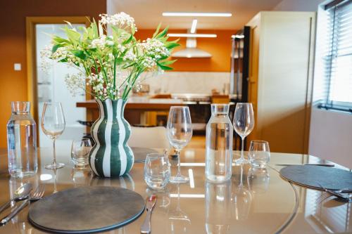 a table with wine glasses and a vase with flowers at No 1 - Bakewell in Bakewell