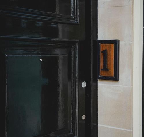 a black door with the number one on it at No 1 - Bakewell in Bakewell