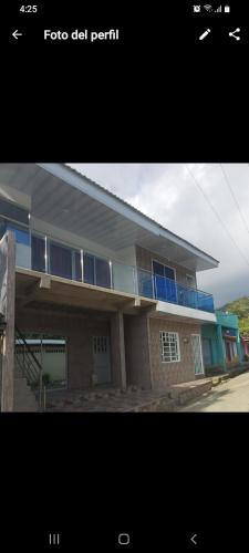a building with blue windows at Hostal marazulcapurgana in Capurganá
