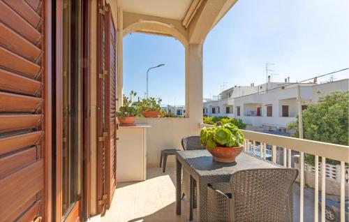 a patio with a table and chairs on a balcony at La Rosa Dei Venti in Villanova di Ostuni