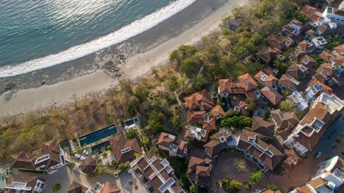an overhead view of a beach with houses and the ocean at Las Catalinas Doorway in Playa Flamingo