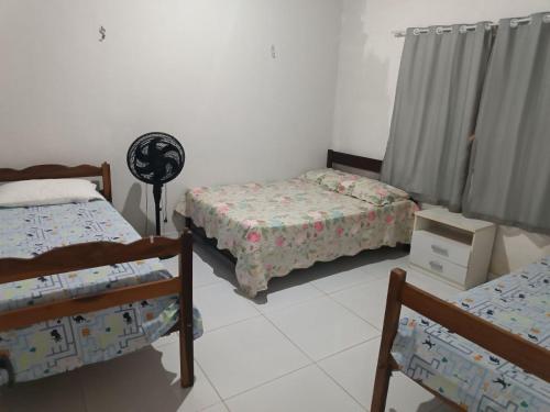 Postel nebo postele na pokoji v ubytování Aluguel por temporada em Luis Correia