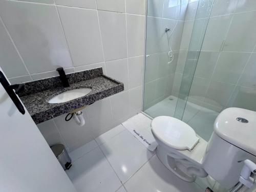 a bathroom with a toilet and a sink and a shower at Pousada Ilha grande in Morro da Marinha