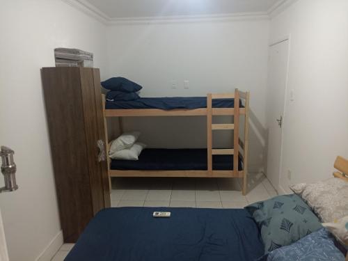 a room with two bunk beds and a bed at Bella house in Balneário Camboriú