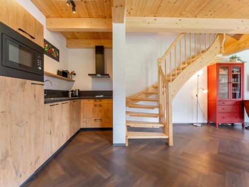 a staircase in a kitchen with wooden floors at Obermöschach 10A in Obermöschach