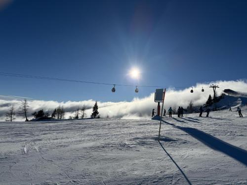 a group of people on a ski lift in the snow at Obermöschach 10A in Obermöschach