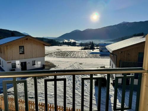 a view of a snow covered field from a balcony at Obermöschach 10A in Obermöschach